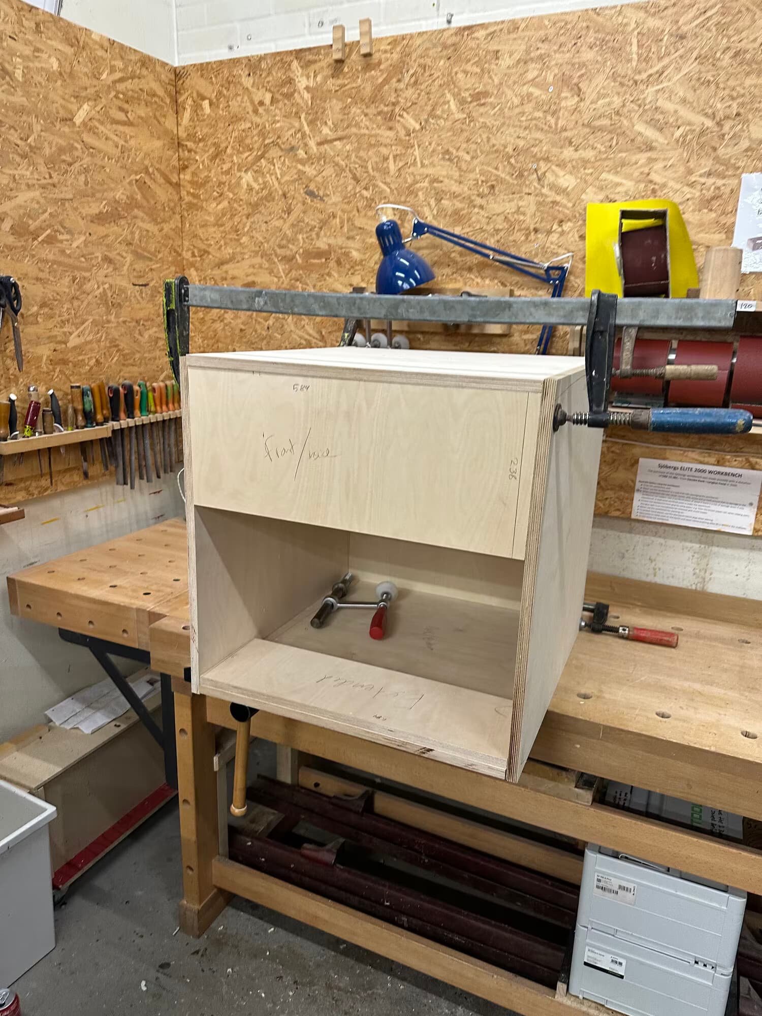 Enclosure panels glued and clamped together on a workbench