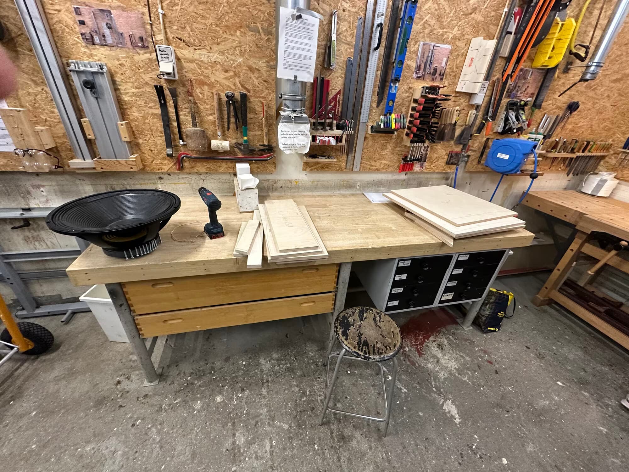 18-inch driver and cut plywood panels laid out on a workbench